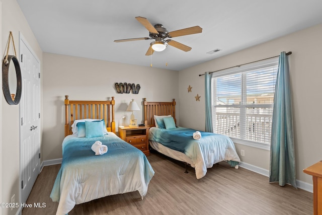 bedroom with ceiling fan and wood-type flooring