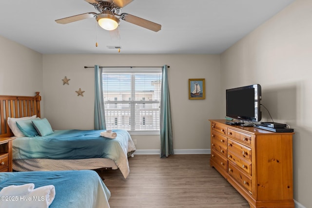 bedroom with hardwood / wood-style flooring and ceiling fan