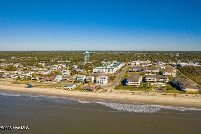 birds eye view of property with a view of the beach and a water view