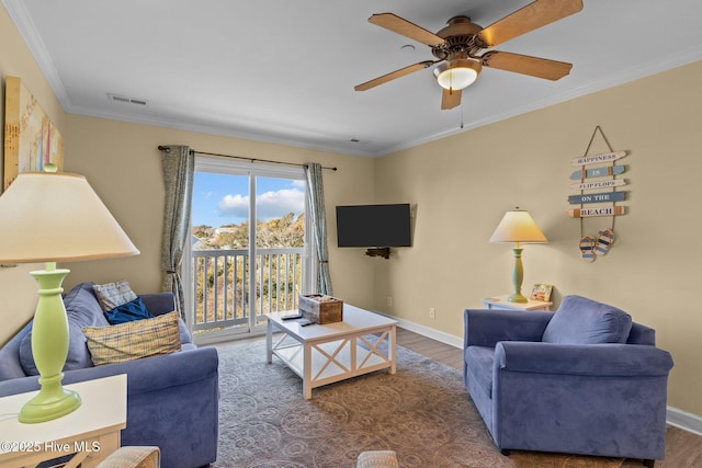 living room with dark hardwood / wood-style flooring, ornamental molding, and ceiling fan