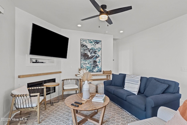 living room featuring hardwood / wood-style flooring and ceiling fan