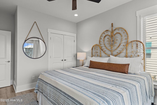 bedroom featuring wood-type flooring, a closet, and ceiling fan