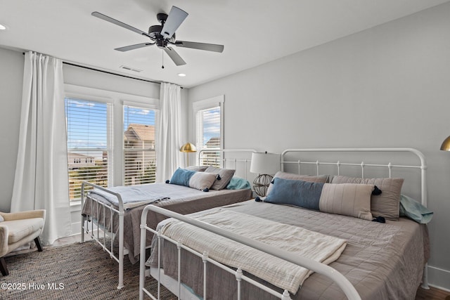 bedroom with wood-type flooring and ceiling fan