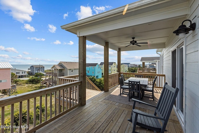 wooden terrace featuring a water view and ceiling fan