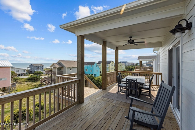 1903 Emerald Dr, Emerald Isle, NC 28594 - deck featuring a ceiling fan, outdoor dining area, and a residential view