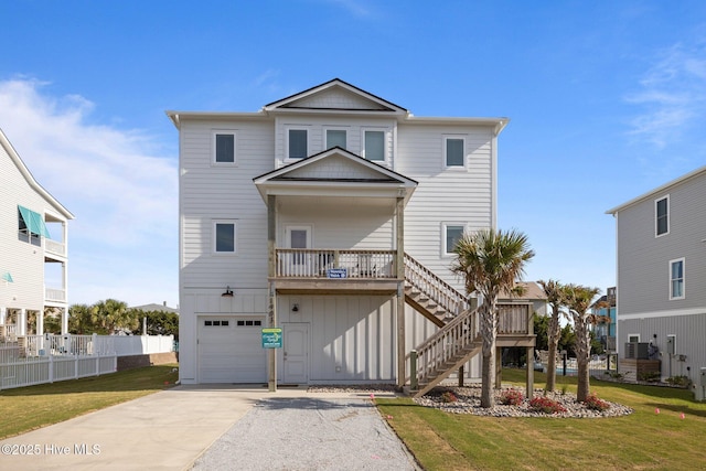 1903 Emerald Dr, Emerald Isle, NC 28594 - raised beach house featuring a garage, concrete driveway, stairs, and board and batten siding