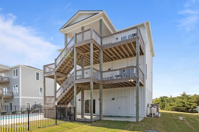 1903 Emerald Dr, Emerald Isle, NC 28594 - rear view of house featuring stairs, board and batten siding, a patio, and a deck