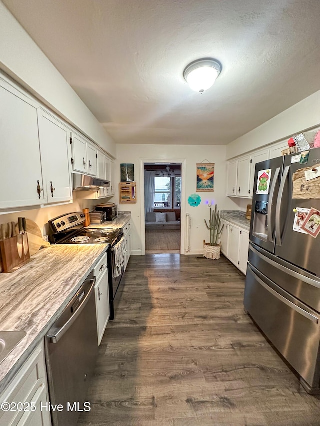 kitchen with white cabinetry, appliances with stainless steel finishes, and dark wood-type flooring