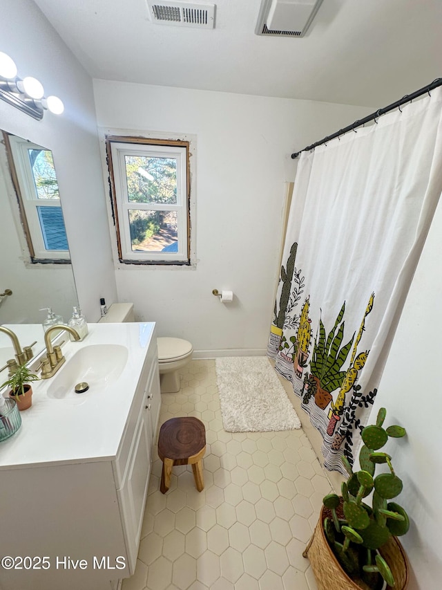 bathroom with vanity, toilet, and a shower with shower curtain