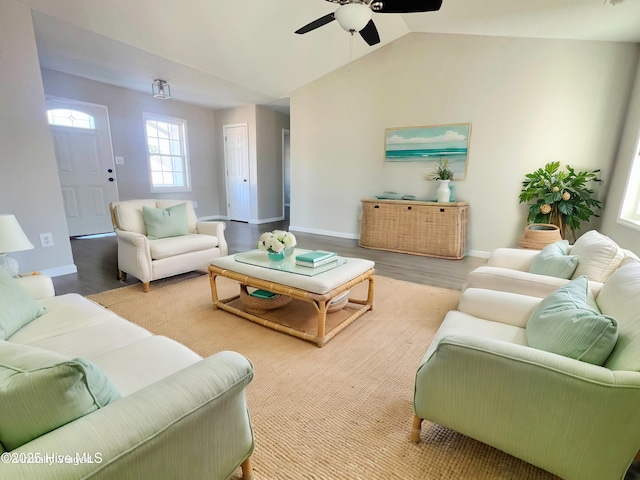 living room with vaulted ceiling, ceiling fan, and light wood-type flooring