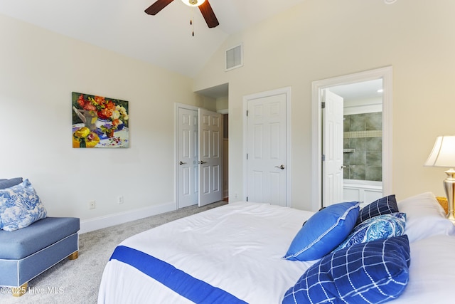 carpeted bedroom featuring lofted ceiling, connected bathroom, and ceiling fan