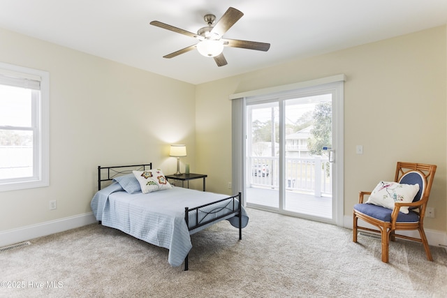 bedroom with light colored carpet, access to exterior, and ceiling fan