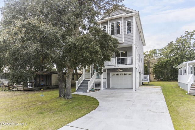 rear view of property featuring a balcony, a garage, and a storage shed