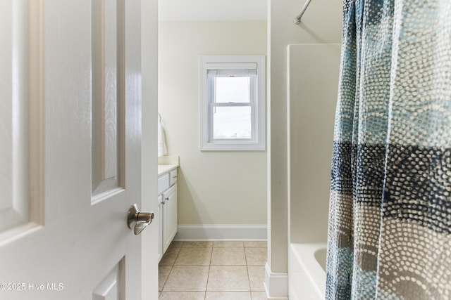 bathroom featuring vanity, bathtub / shower combination, and tile patterned flooring