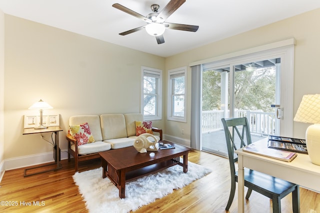 living room with hardwood / wood-style floors and ceiling fan