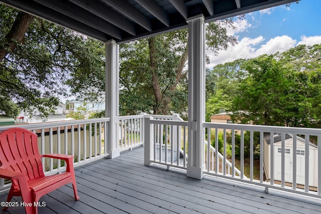 wooden terrace with a storage shed