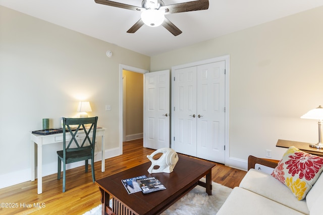 living room with hardwood / wood-style flooring and ceiling fan