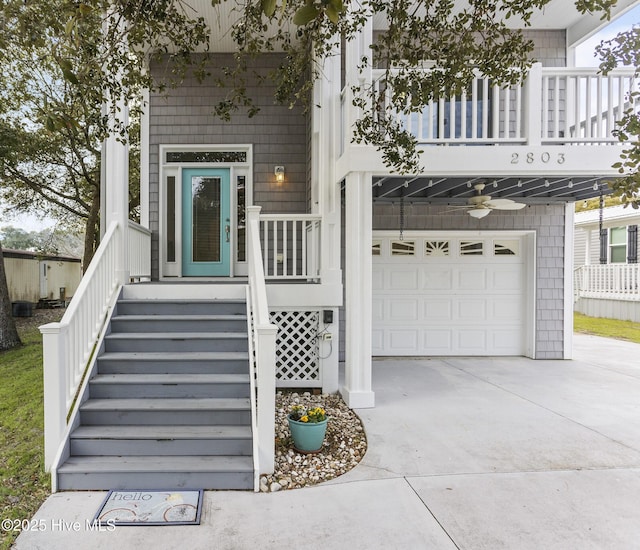 entrance to property featuring a garage and a balcony