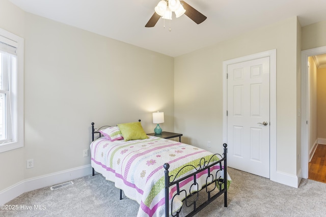 bedroom with light colored carpet and ceiling fan