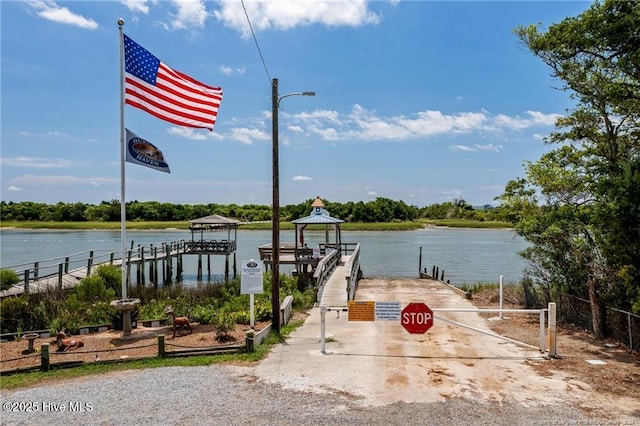 view of dock featuring a gazebo and a water view