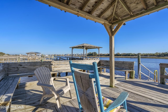 view of dock with a gazebo and a water view