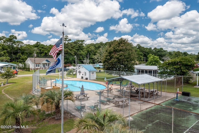 view of swimming pool with a yard, a water slide, and a patio