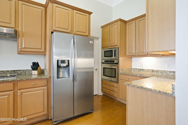 kitchen with appliances with stainless steel finishes, light stone counters, ornamental molding, light hardwood / wood-style floors, and light brown cabinetry