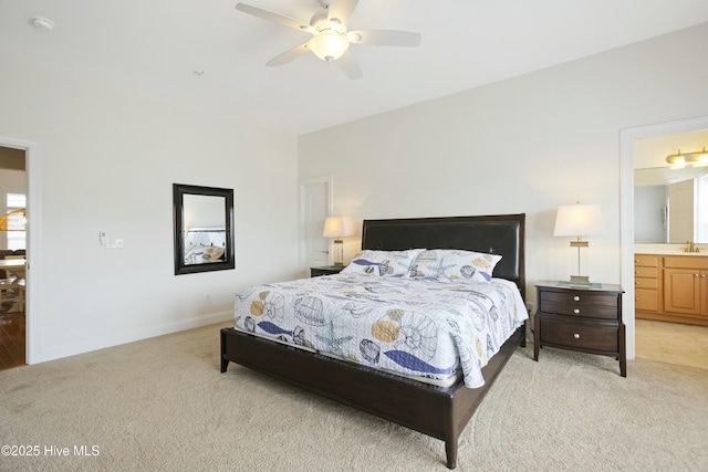 carpeted bedroom with ceiling fan, connected bathroom, and sink