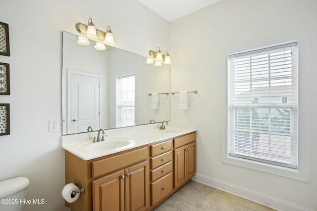 bathroom featuring vanity, tile patterned floors, toilet, and a healthy amount of sunlight