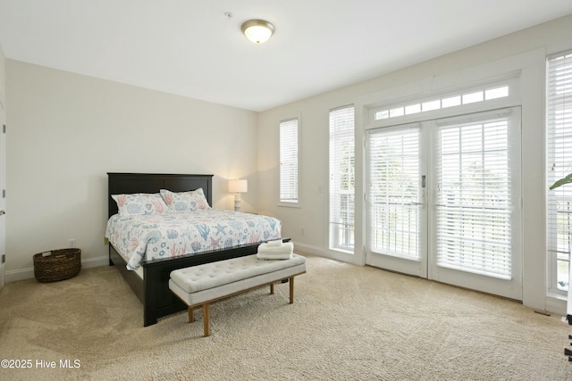 bedroom featuring access to exterior and carpet floors