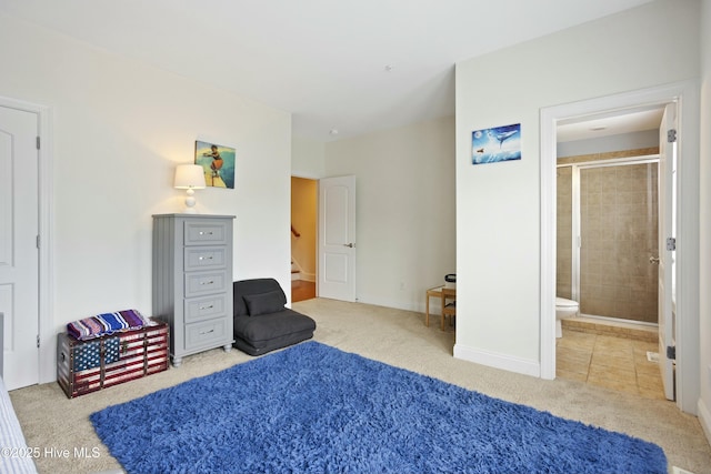 bedroom featuring ensuite bathroom and carpet floors