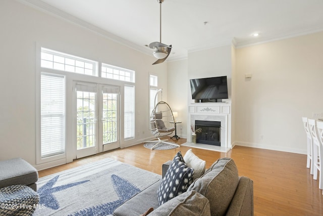 living room with french doors, crown molding, and light hardwood / wood-style flooring