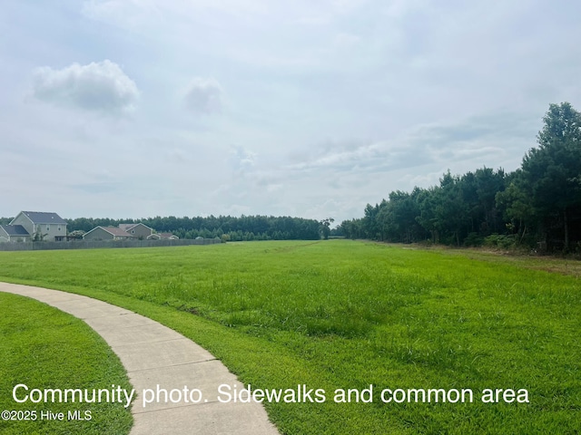 surrounding community with a yard and a rural view