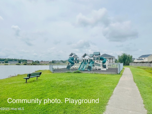 exterior space featuring a playground, a water view, and a yard