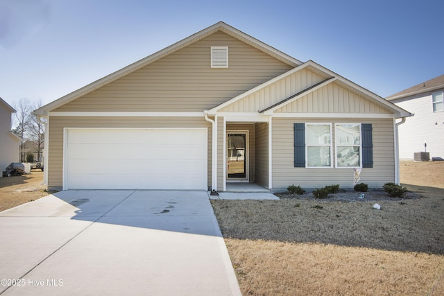 view of front of house with a garage and central air condition unit