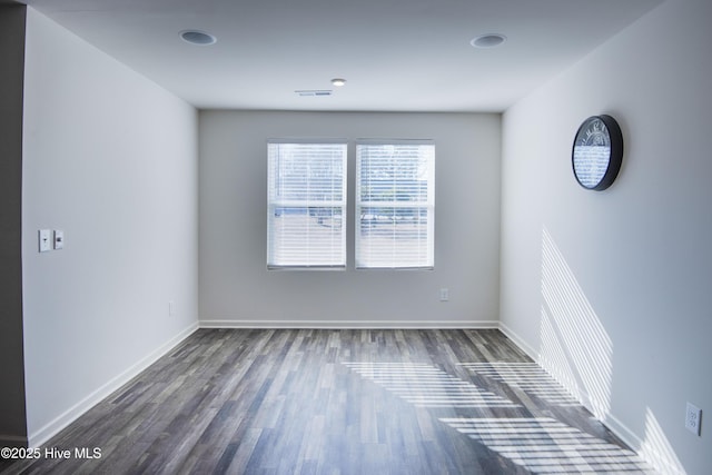 empty room featuring dark wood-type flooring