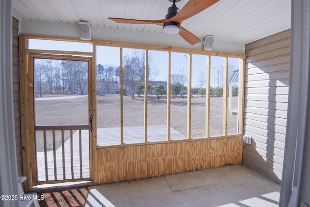 unfurnished sunroom with ceiling fan and a wealth of natural light