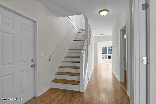 stairway featuring wood-type flooring