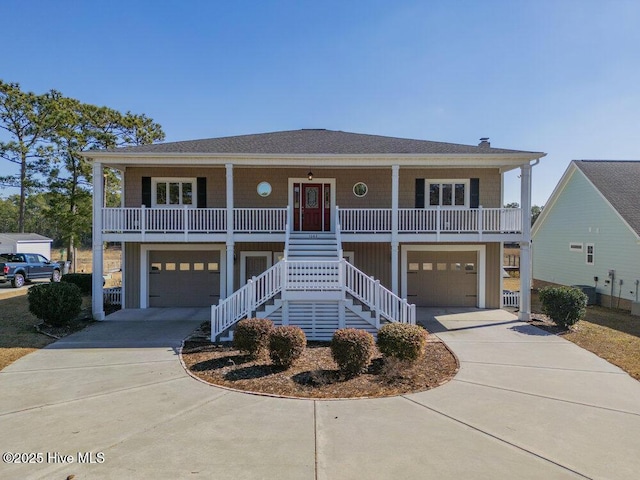 coastal home with a garage and a porch