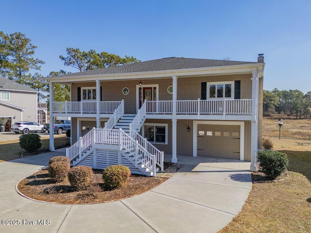 beach home featuring a garage and covered porch