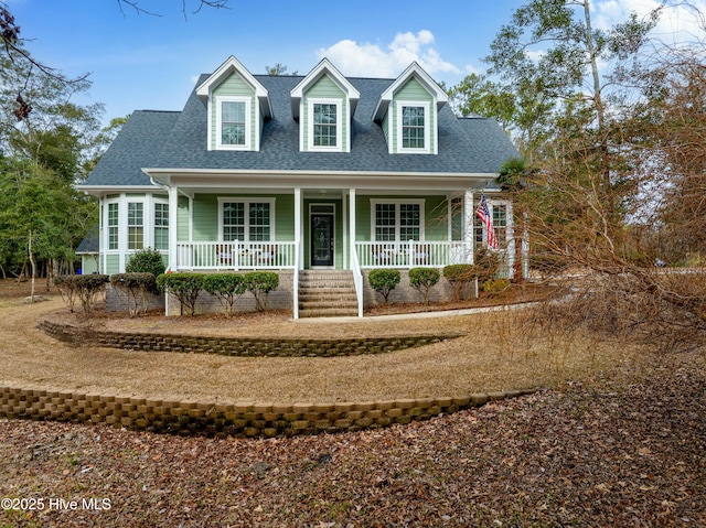 cape cod home featuring a porch