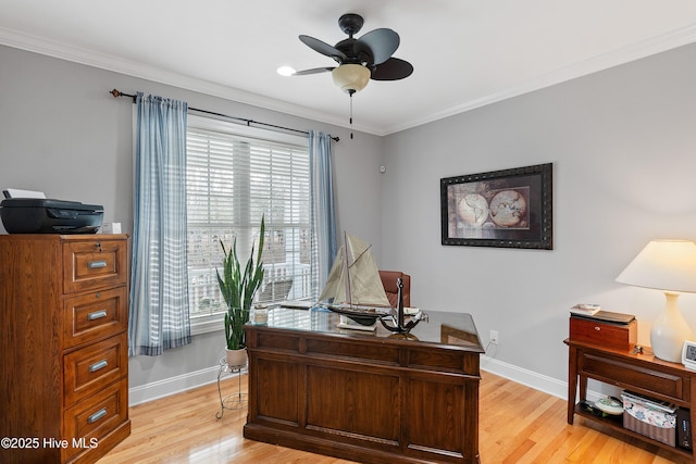 office space with light wood-style floors, baseboards, a ceiling fan, and crown molding