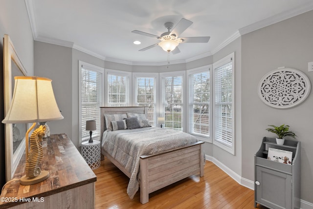 bedroom featuring baseboards, ceiling fan, light wood-type flooring, and crown molding