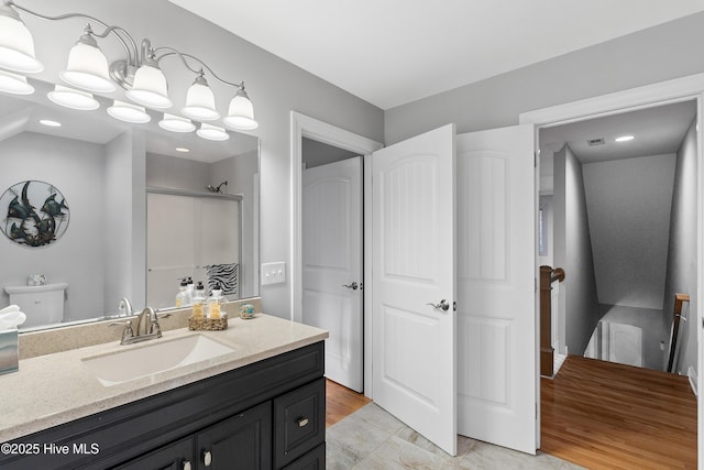 bathroom featuring a shower stall and vanity