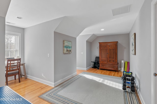 bedroom featuring baseboards, visible vents, and wood finished floors