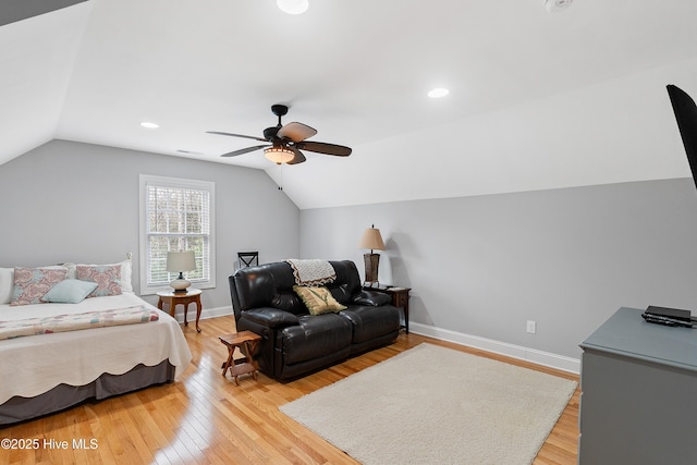 bedroom with lofted ceiling, baseboards, and light wood-style floors