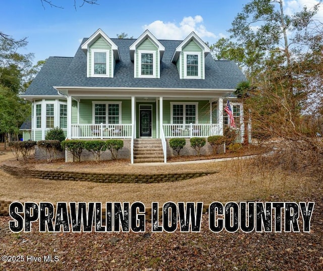 new england style home featuring a shingled roof and covered porch