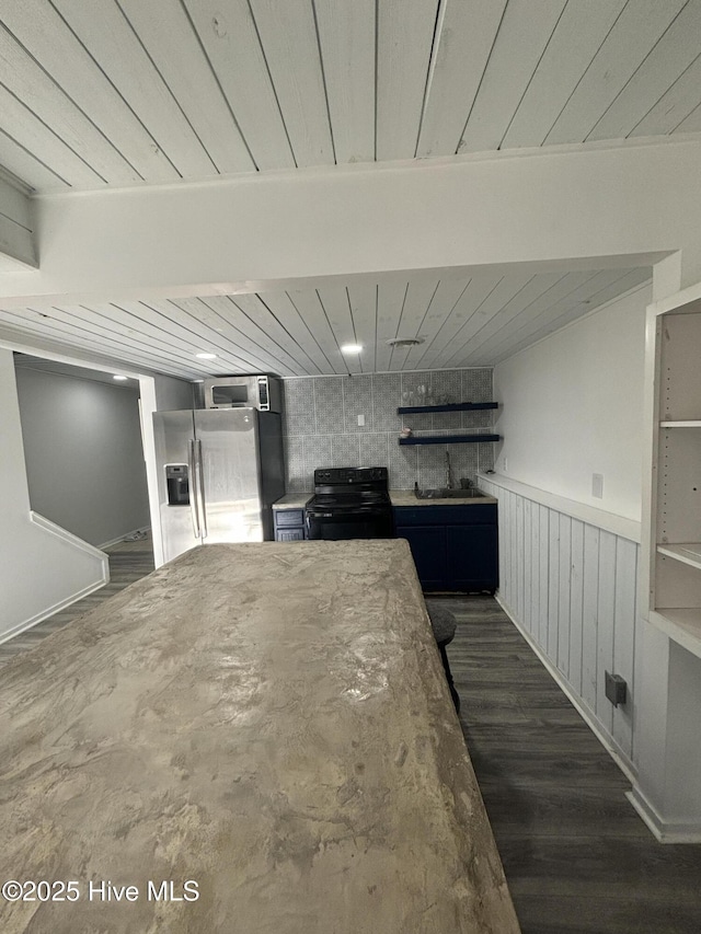 kitchen featuring dark hardwood / wood-style flooring, stainless steel fridge with ice dispenser, electric range, and sink