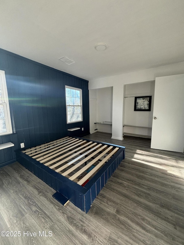 bedroom with dark hardwood / wood-style flooring