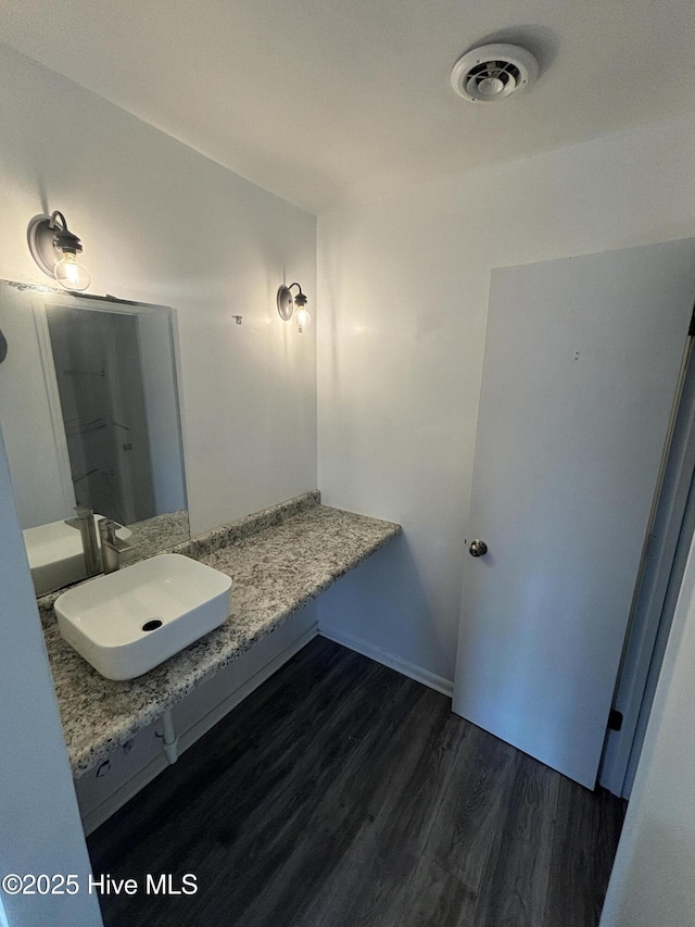 bathroom with sink and hardwood / wood-style flooring